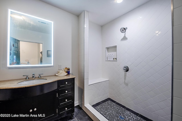 bathroom featuring vanity and a tile shower