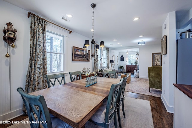 dining room with visible vents, baseboards, recessed lighting, dark wood-style flooring, and a notable chandelier