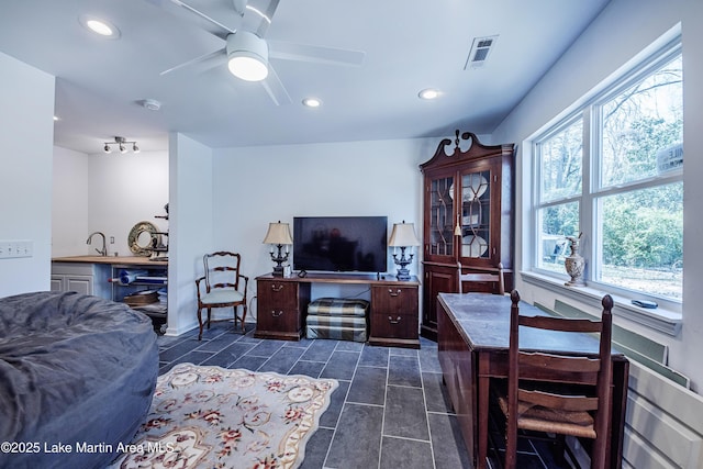 living room featuring dark tile patterned floors, visible vents, recessed lighting, and ceiling fan