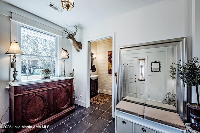 bathroom with tile patterned flooring, visible vents, vanity, and baseboards