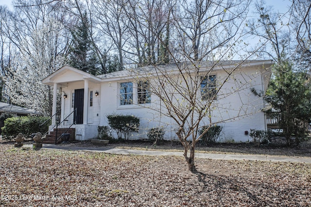 view of front of property featuring crawl space and brick siding