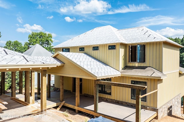 rear view of property featuring a wooden deck