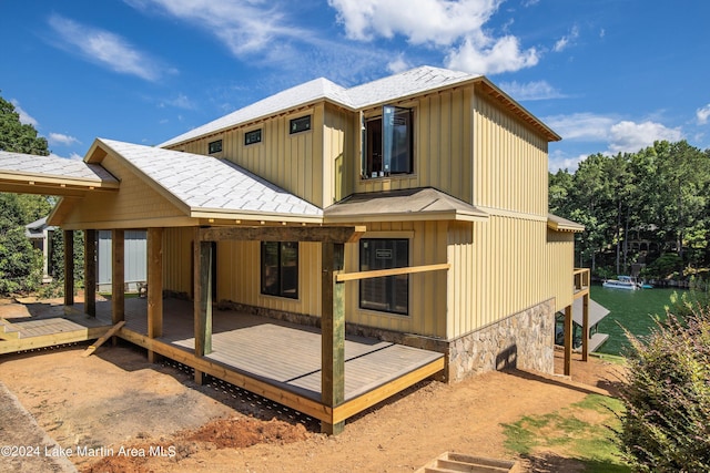 rear view of house featuring a deck