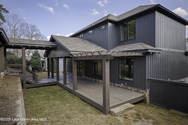 rear view of house featuring a wooden deck