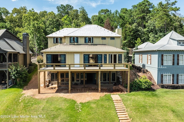 back of house featuring a patio, a deck, and a lawn