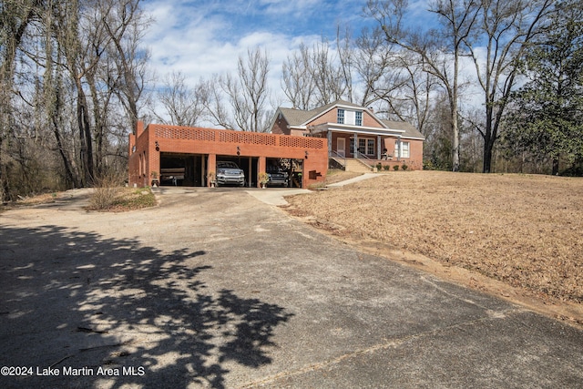 view of front of property featuring a carport and a porch