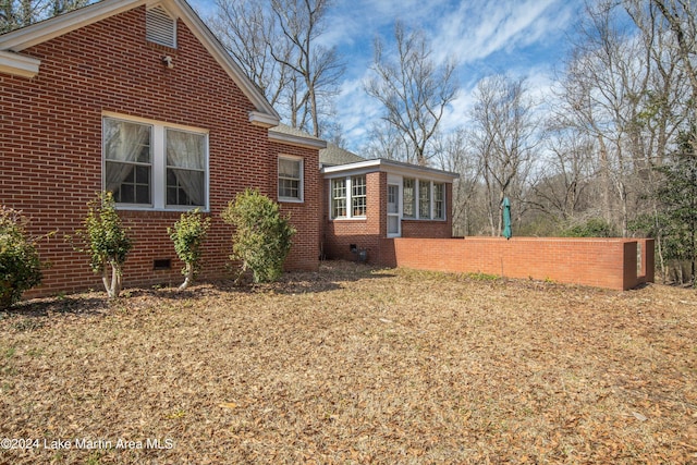 view of side of home featuring a sunroom