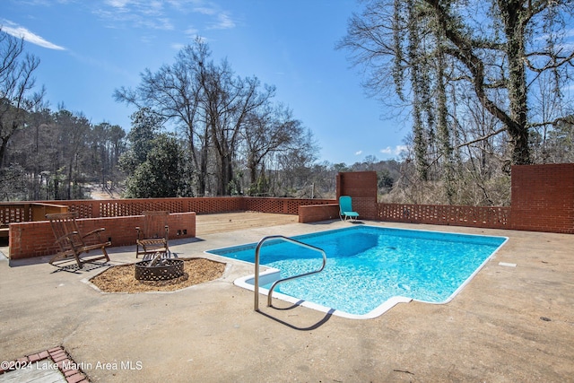 view of pool featuring a fire pit and a patio area