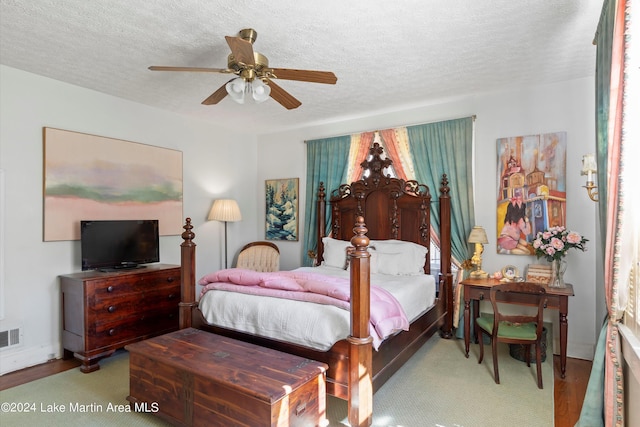 bedroom featuring ceiling fan and a textured ceiling