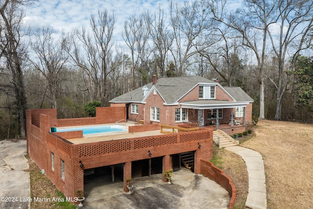 back of property with covered porch