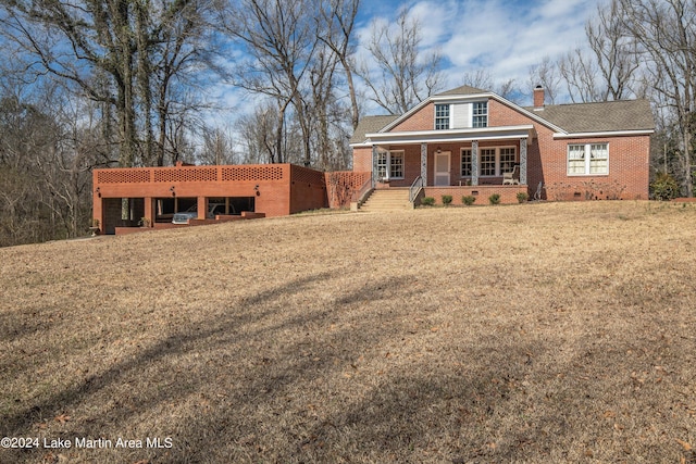 view of front of home with a front yard and covered porch