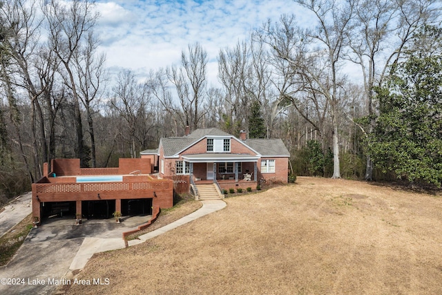 exterior space with a porch and a front lawn