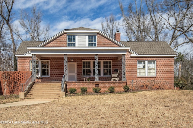 view of front of house with a porch and a front yard