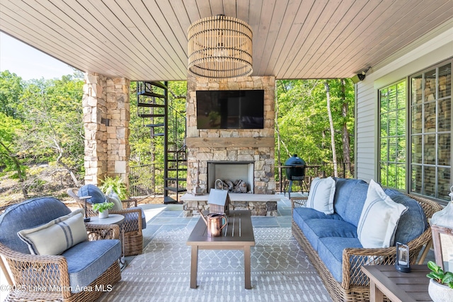 view of patio featuring an outdoor living space with a fireplace