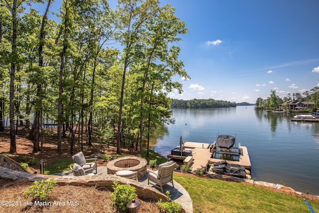 dock area with a fire pit and a water view