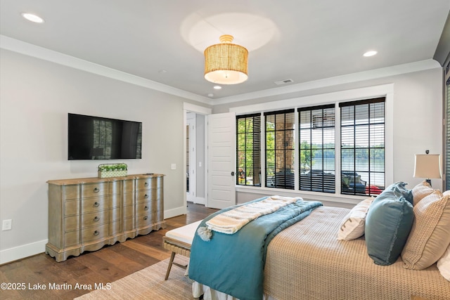 bedroom with hardwood / wood-style flooring and crown molding