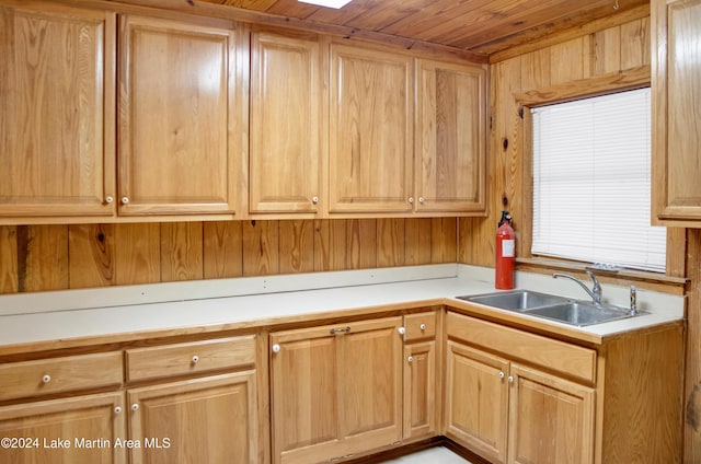 kitchen with wood walls, sink, and wood ceiling