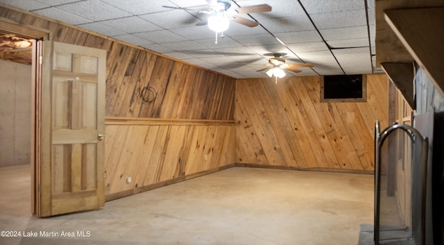 basement featuring wood walls