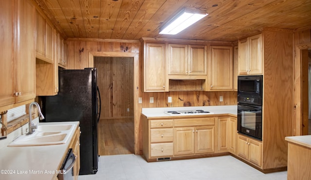 kitchen with wood walls, wooden ceiling, black appliances, sink, and light brown cabinetry