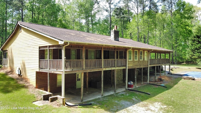 back of house featuring a yard, a patio, and a deck