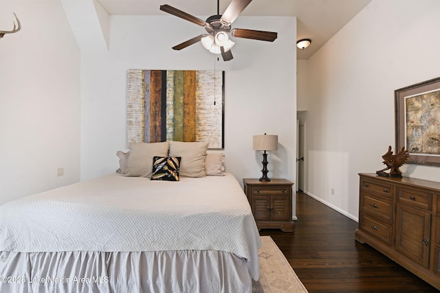 bedroom featuring dark wood-style flooring, baseboards, and ceiling fan