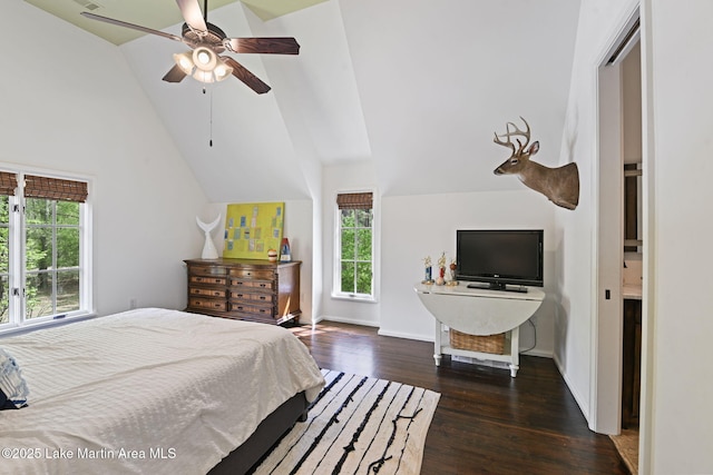 bedroom with multiple windows, wood finished floors, vaulted ceiling, and ceiling fan