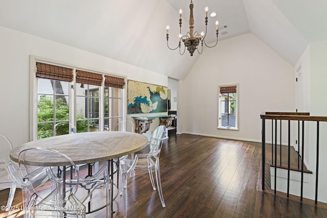 dining space with a chandelier, lofted ceiling, hardwood / wood-style floors, and baseboards