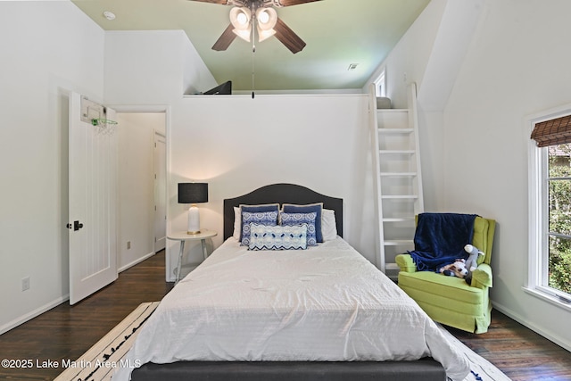 bedroom featuring wood finished floors, baseboards, and ceiling fan