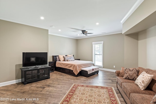 bedroom featuring hardwood / wood-style flooring, ornamental molding, and ceiling fan