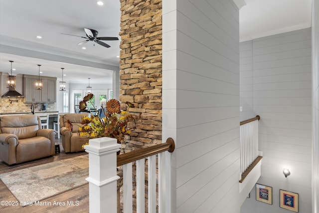 stairway featuring hardwood / wood-style flooring and ceiling fan