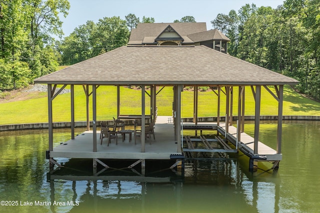 dock area with a lawn and a water view