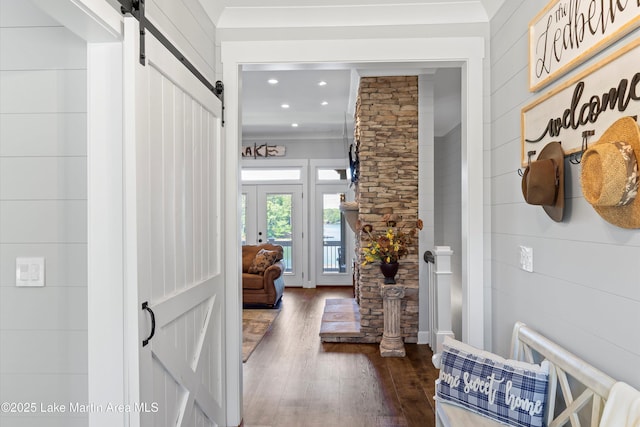 foyer featuring dark hardwood / wood-style flooring, a barn door, and french doors