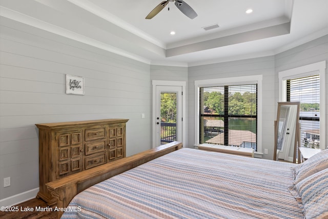 bedroom featuring access to outside, ornamental molding, a tray ceiling, ceiling fan, and hardwood / wood-style floors