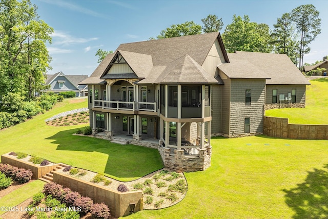 back of property with a yard and a patio area