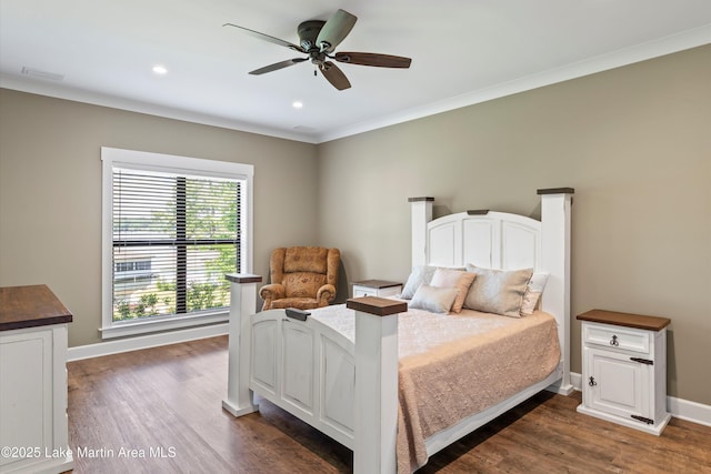 bedroom with ceiling fan, ornamental molding, and dark hardwood / wood-style flooring