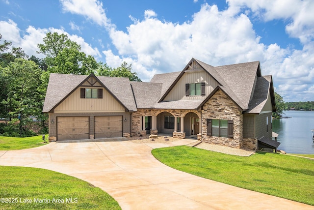 craftsman-style house featuring a garage, a front lawn, and a water view