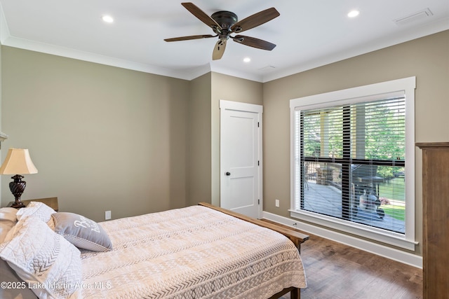 bedroom featuring ceiling fan, ornamental molding, and dark hardwood / wood-style floors