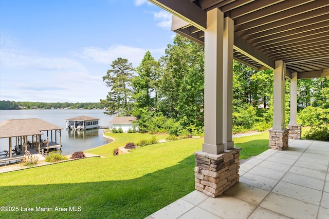 view of yard featuring a water view and a boat dock