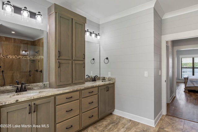 bathroom featuring vanity, crown molding, tiled shower, and wood walls