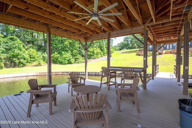 wooden deck with ceiling fan and a yard