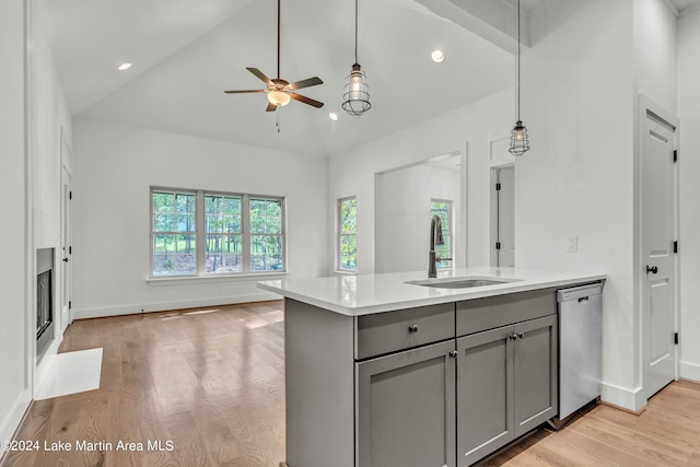 kitchen featuring ceiling fan, sink, light hardwood / wood-style flooring, stainless steel dishwasher, and gray cabinets