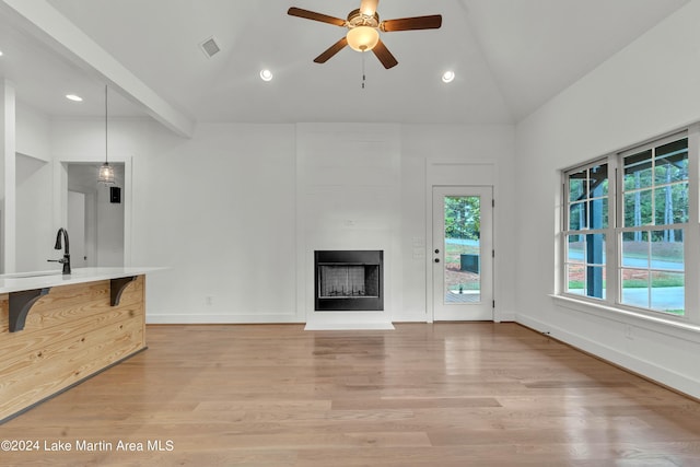 124 Village Pkwy, Dadeville, AL 36853 - unfurnished living room with light wood-type flooring, visible vents, a ceiling fan, and a large fireplace