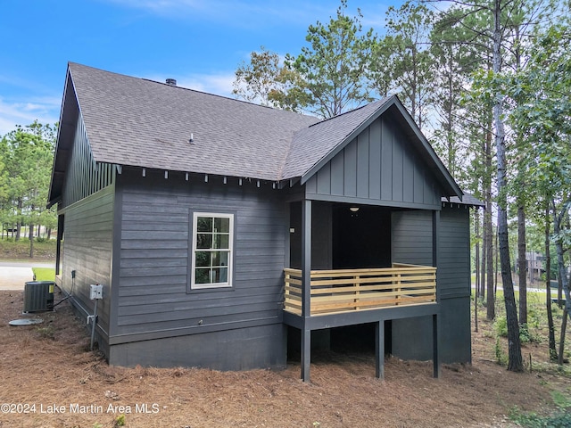 back of house featuring central AC unit and a wooden deck