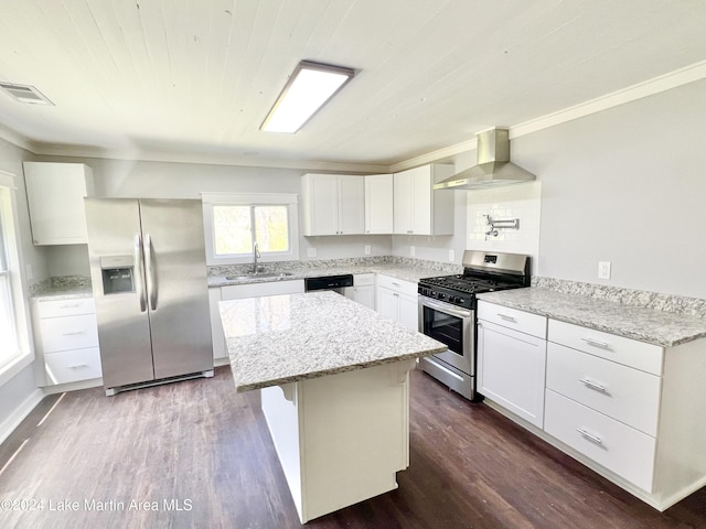 kitchen featuring wall chimney exhaust hood, white cabinetry, dark wood-type flooring, and appliances with stainless steel finishes