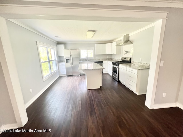 kitchen featuring light stone countertops, appliances with stainless steel finishes, wall chimney range hood, a center island, and dark hardwood / wood-style floors