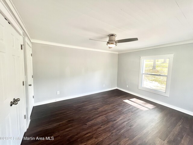 unfurnished bedroom featuring crown molding, ceiling fan, and dark wood-type flooring