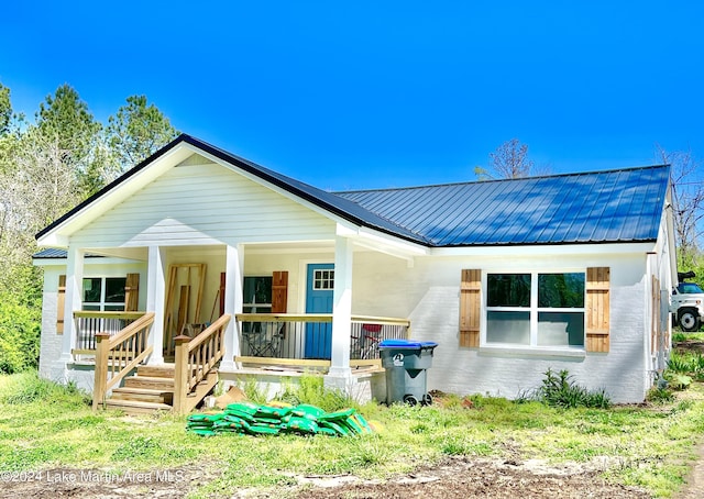 rear view of house featuring a porch