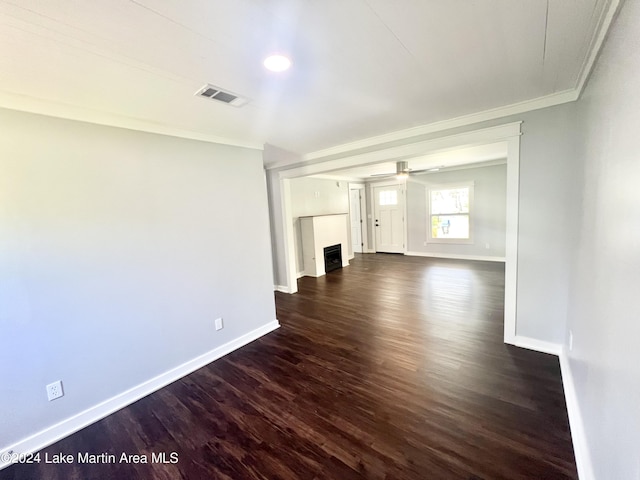 unfurnished living room featuring crown molding and dark hardwood / wood-style floors