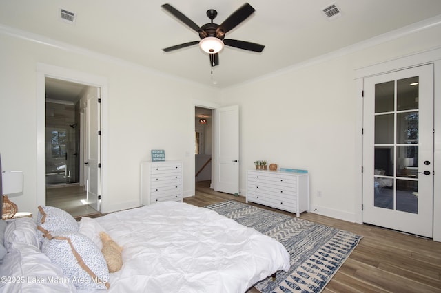 bedroom with ornamental molding, wood finished floors, visible vents, and baseboards