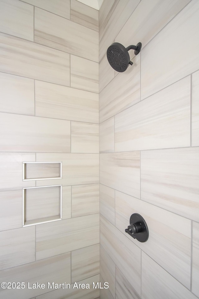 interior details featuring a tile shower